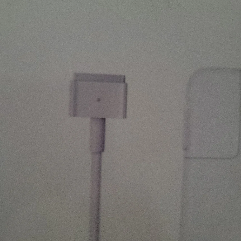 Apple 45W Magsafe 2 power adapter for MacBook Air.